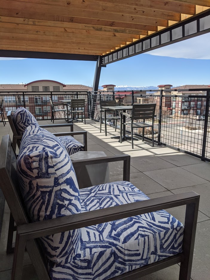 South Denver Coworking space sunny patio with chairs and mountain views