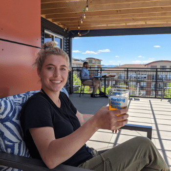 Sophie drinking a beer while coworking