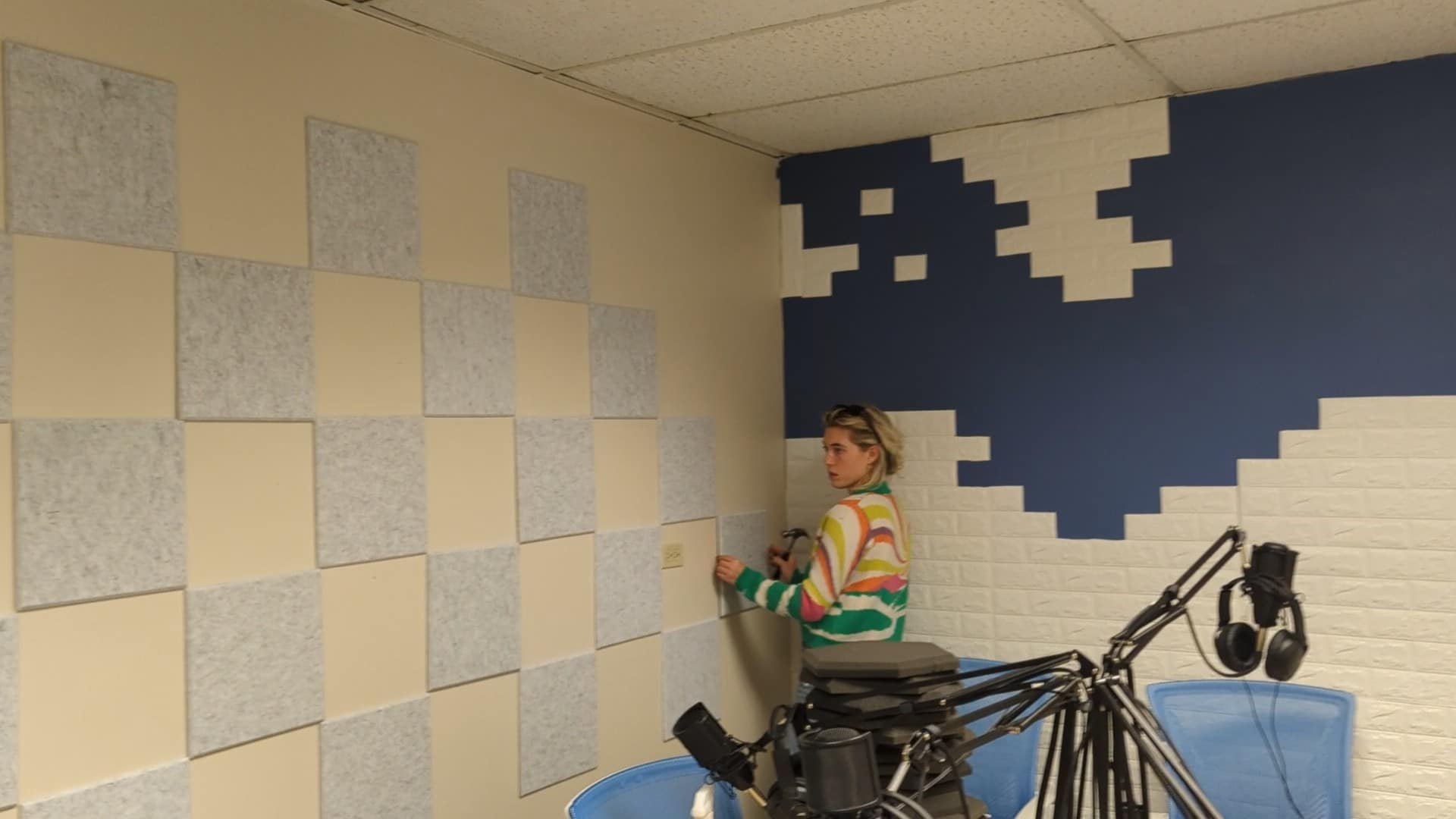 Sophie adding foam padding to the podcasting studio at Creative Density Coworking in Denver